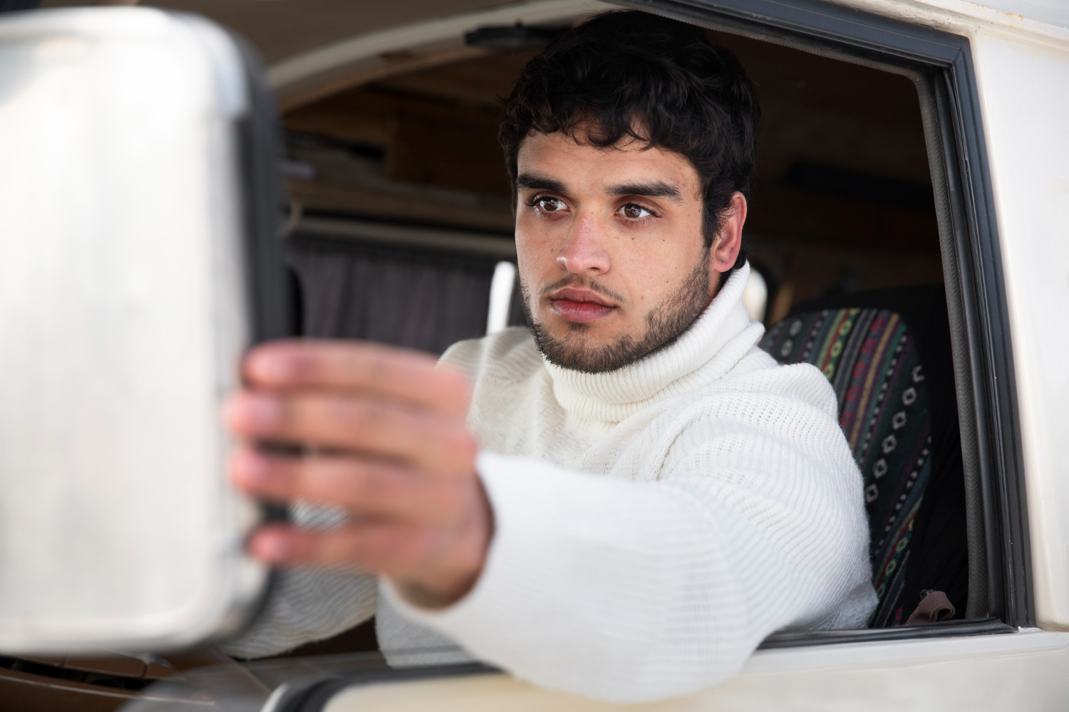 2149295086 Commercial truck driver checking mirrors for blind spot awareness