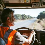 CDL driver practicing defensive driving techniques on a California highway